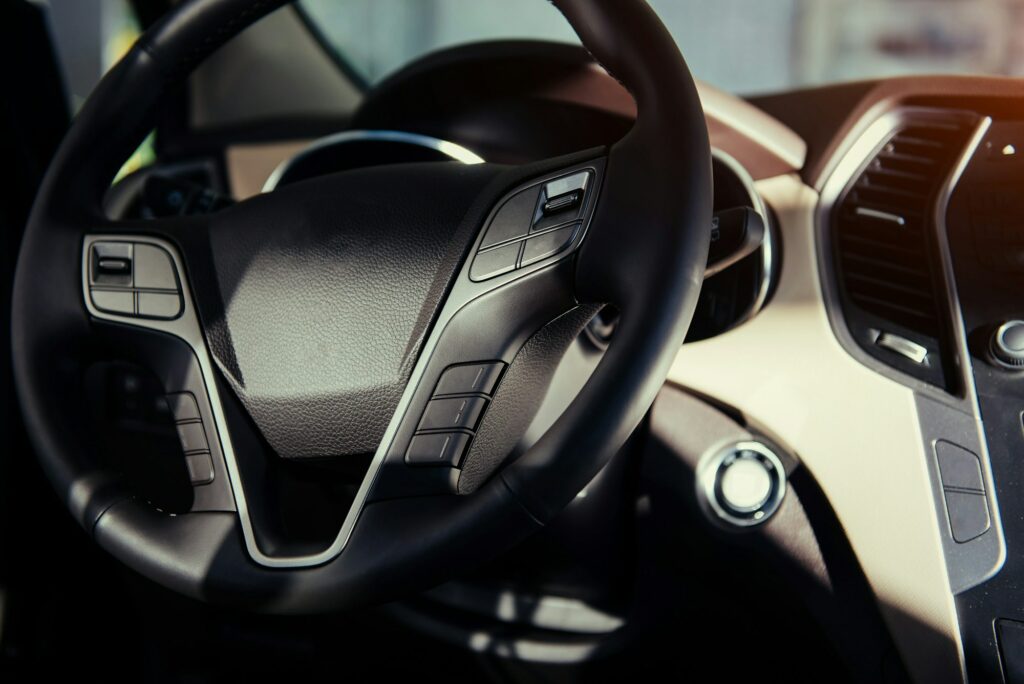 Modern car interior dashboard and steering wheel.